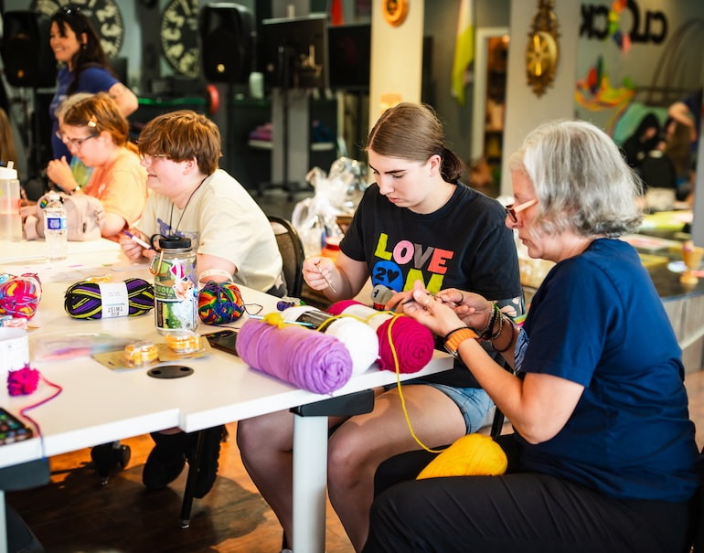 Several generations of participants in Craft Night at Clock Inc. LGBT+ Community Center in Rock Island with Free Mom Hugs