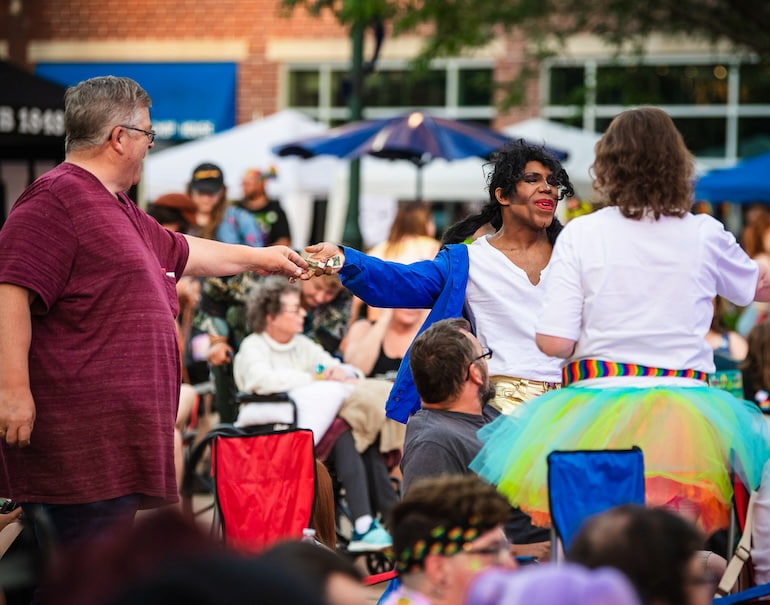 Izzy A Mess, Michael Jackson impersonator, receiving tips at Pride Party at Bass Street Landing June 15.