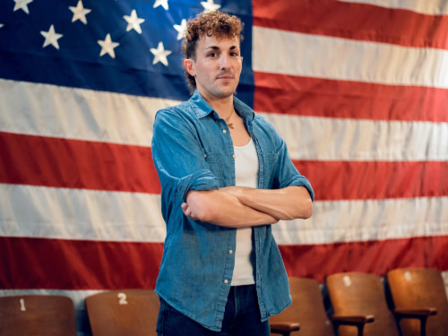 Adam Peters in front of flag